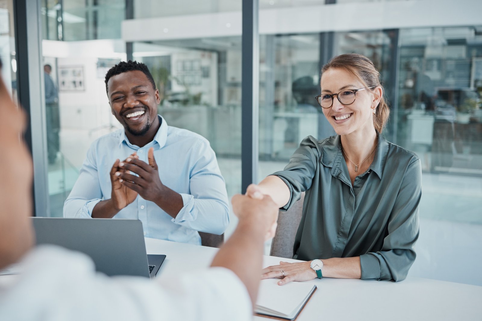 Business people, handshake and interview in celebration for recruitment, hiring and employment at t
